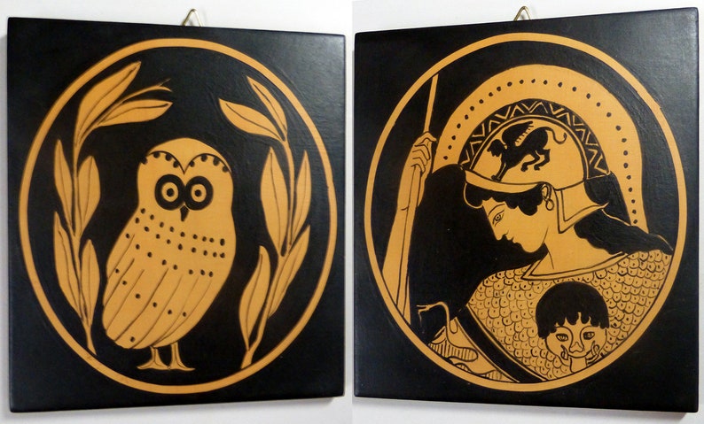 May include: Two square wall art pieces with black backgrounds and gold-colored illustrations. One features an owl within a circular frame of leaves. The other depicts a figure in a helmet and armor, also within a circle.