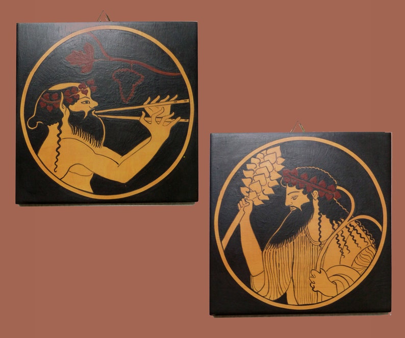 May include: Two square wall art pieces with black backgrounds and circular illustrations. One shows a figure playing a flute, the other depicts two figures holding wheat. The figures are in tan with red and gold accents.
