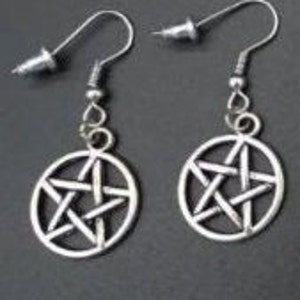 May include: A pair of silver earrings with a pentagram design. The earrings are made of metal and have a simple, minimalist style.