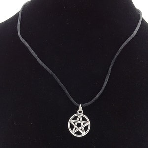 May include: A silver pentagram pendant necklace on a black cord.