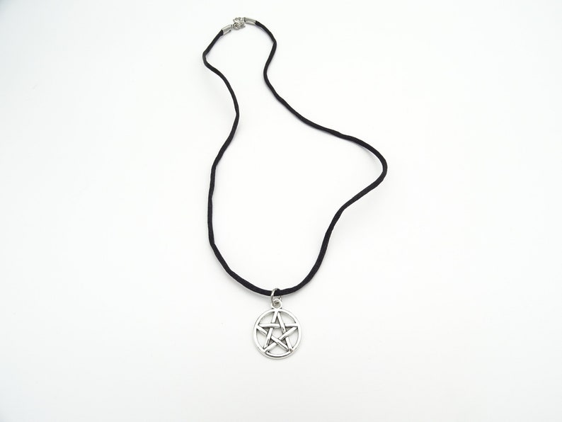 May include: A black cord necklace with a silver pentagram pendant.