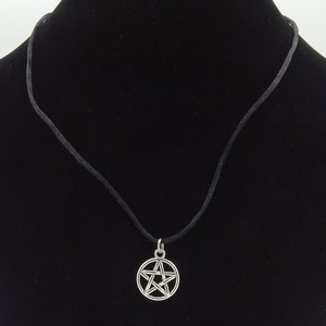 May include: A black cord necklace with a silver pentagram pendant.