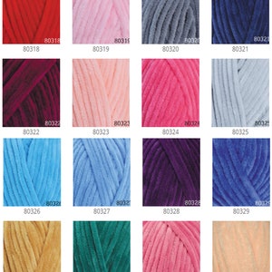 May include: A collection of colorful yarn skeins in various shades, including red, pink, blue, and green. Each skein has a soft, velvety texture. The image displays a range of colors suitable for knitting and crochet projects.