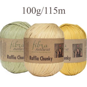 May include: Three balls of Fibra Natura Raffia Chunky yarn in light green, beige, and yellow. Each ball has a brown paper label with the text 'fibra natura Raffia Chunky' and a small image of a person wearing a hat. The text '100g/115m' is visible.