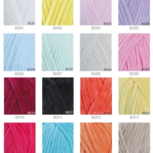 May include: A collection of colorful yarn skeins in various shades, including white, yellow, pink, purple, blue, green, and red. Each skein is labeled with a number. The yarn appears soft and plush, suitable for knitting or crochet projects.