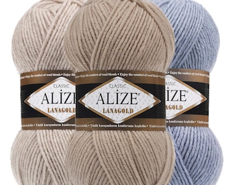 May include: Three skeins of Alize Lanagold Classic yarn in beige, tan, and light blue. Each skein features a black and white paper label with the text "CLASSIC ALIZE LANAGOLD" and "Wool Acrylic Blend" printed at the top of the image.