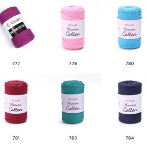 May include: A collection of colorful YarnArt Macrame Cotton yarn skeins. The colors include shades of purple, pink, blue, red, teal, and navy. Each skein has a label with the brand name and product details. The numbers 777, 779, 780, 781, 783, and 784 are visible.