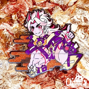 Puede incluir: Un colorido pin de esmalte con un personaje de anime estilizado con cabello blanco, ojos rojos y armadura púrpura. El pin tiene un borde dorado y naranja y un pequeño logotipo en la esquina inferior derecha. El fondo es dorado.