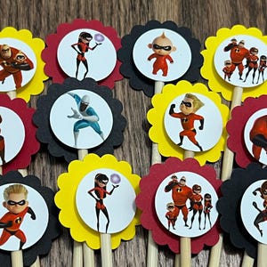 May include: Set of 12 cupcake toppers featuring characters from the Incredibles movie. The toppers are printed on round circles with scalloped edges and attached to wooden sticks. The characters include Mr. Incredible, Mrs. Incredible, Violet, Dash, Jack-Jack, Frozone, and Syndrome.