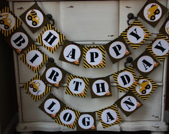May include: A yellow and black construction-themed birthday banner with the words "Happy Birthday Logan".