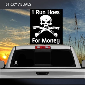 May include: Black and white decal with a skull and crossbones design. The text reads "I Run Hoes For Money".