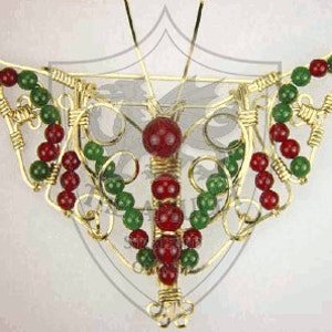May include: A gold wire butterfly brooch with red and green beads. The butterfly's wings are made of wire and beads, and the body is a single red bead.