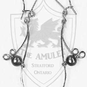 May include: A pair of silver dangle earrings with a black bead on each earring. The earrings have a simple design with a small loop at the top and a curved wire that hangs down to the bead.