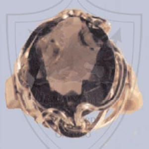 May include: A gold ring with a large, oval-shaped, dark gray gemstone set in a swirling, ornate design.