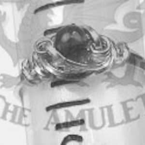 May include: A silver ring featuring a black gemstone set within an intricate, ornate design.