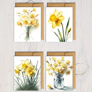 May include: Four greeting cards featuring watercolor illustrations of daffodils. The cards showcase various arrangements: a bouquet tied with twine, a single flower, a cluster with grass, and a vase of flowers. Each card is paired with a brown envelope.