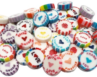 May include: Assortment of colorful round candies with various wedding-themed messages, such as "Love", "Just Married", "Bride", "Groom", and "Happiness Love Laughter".