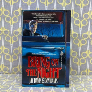 May include: A paperback book titled "Bring on the Night" by Jay Davis & Don Davis. The cover features a menacing figure in a car, with the title in red and the tagline "A savage killer stalks the dark streets of Chicago."