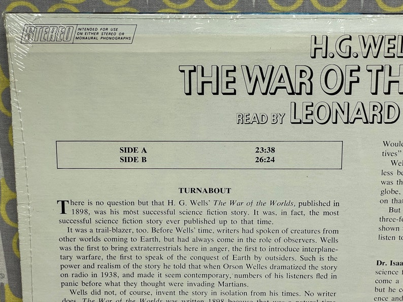May include: A vintage record album cover featuring a black and white image of H.G. Wells. The album title is "The War of the Worlds" and the text "Read by Leonard" is printed below. The album cover also includes the side A and side B track times.