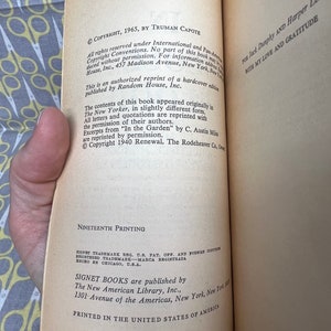 May include: A close-up of the copyright and printing information for a paperback book. The text includes the copyright date, author, publisher, and printing number. The book is printed in the United States of America.