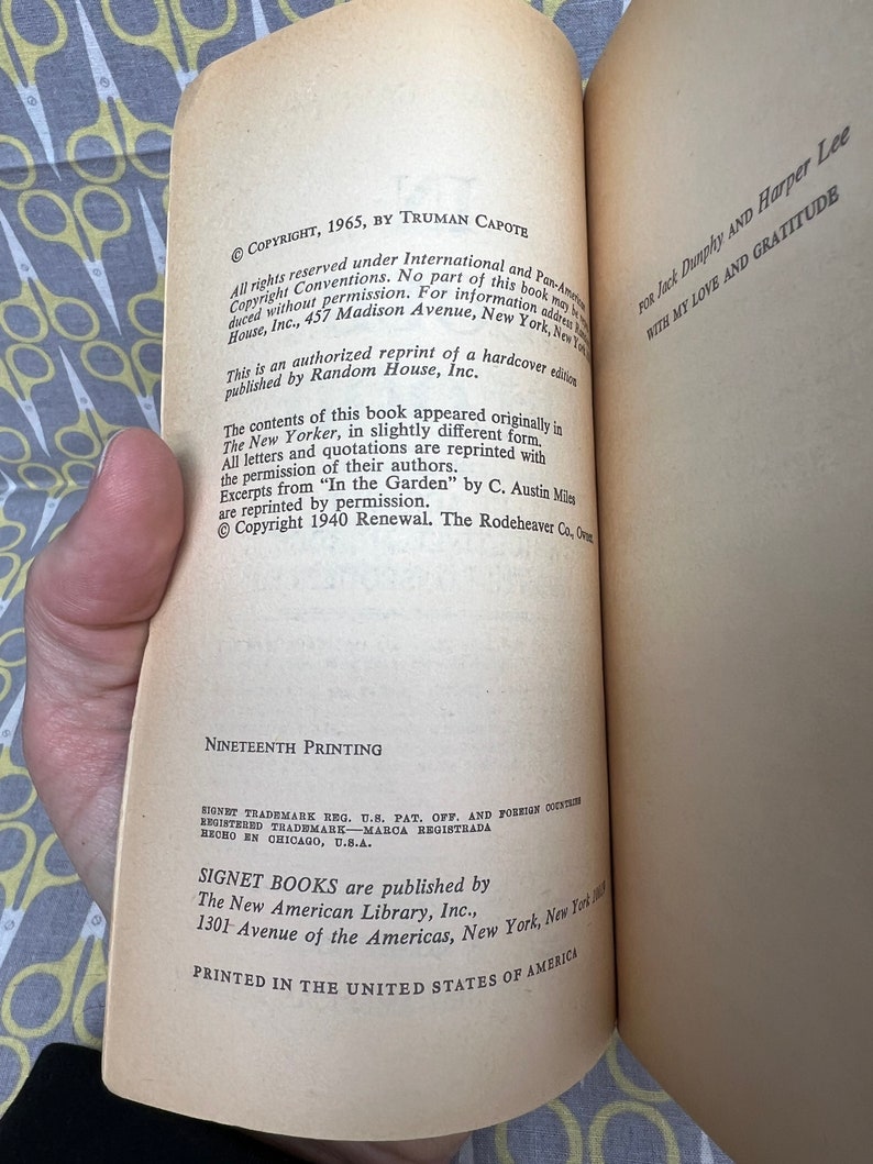 May include: A close-up of the copyright and printing information for a paperback book. The text includes the copyright date, author, publisher, and printing number. The book is printed in the United States of America.