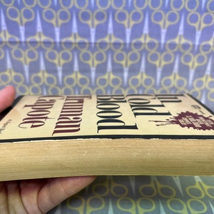 May include: A vintage paperback copy of Truman Capote's In Cold Blood. The book cover features the title in bold black font with a red blood splatter graphic.