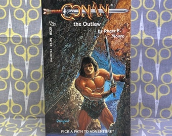 Conan the Outlaw autorstwa Rogera E. Moore'a, książka w miękkiej oprawie, An Endless Quest Book #25, rocznik