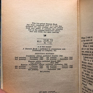 May include: A close-up of a book's copyright page with printing history information. The book is a Bantam edition published by arrangement with Doubleday & Company, Inc. The text includes the printing dates and the number of printings for each edition.