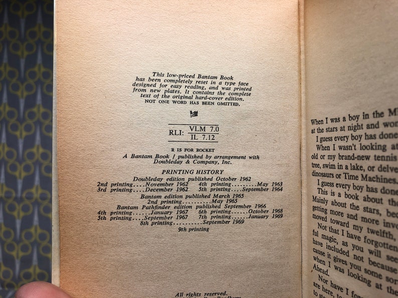 May include: A close-up of a book's copyright page with printing history information. The book is a Bantam edition published by arrangement with Doubleday & Company, Inc. The text includes the printing dates and the number of printings for each edition.