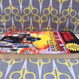 May include: A paperback book titled "Worlds of Power: Ninja Gaiden" with a black and red cover featuring a ninja character in a fighting pose. The book is based on the video game.