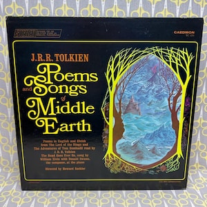 May include: A black vinyl record jacket titled J.R.R. Tolkien Poems and Songs of Middle Earth. The cover features yellow text and a central illustration of a blue mountain landscape framed by yellow tree silhouettes against a black background.