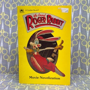 May include: A vintage "Who Framed Roger Rabbit" Golden Book. The cover is yellow with the title in red and white, featuring Roger Rabbit in a red outfit. The book is a movie novelization.
