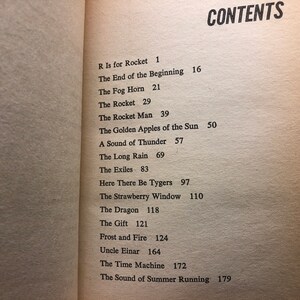May include: A book with a table of contents listing the chapters and page numbers. The chapters include "R Is for Rocket", "The End of the Beginning", "The Fog Horn", "The Rocket", "The Rocket Man", "The Golden Apples of the Sun", "A Sound of Thunder", "The Long Rain", "The Exiles", "Here There Be Tygers", "The Strawberry Window", "The Dragon", "The Gift", "Frost and Fire", "Uncle Einar", "The Time Machine", and "The Sound of Summer Running".