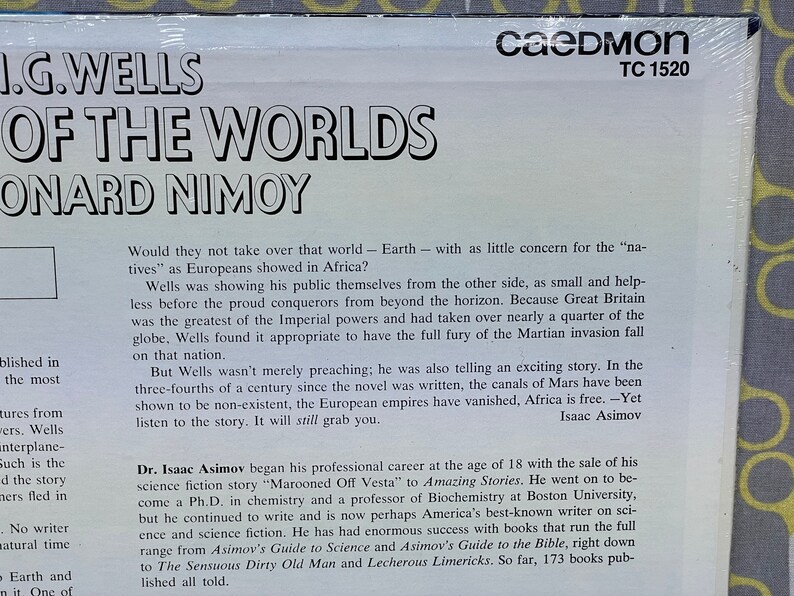 May include: A black and white record album cover with the title "H.G. Wells War of the Worlds" and the name "Leonard Nimoy" in large white letters. The album cover features a white background with black text describing the story and the author.