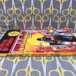 May include: Worlds of Power #3 comic book featuring Ninja Gaiden. The cover features a yellow and red background with a ninja character in the foreground. The text on the cover reads "Ninja Gaiden" and "Worlds of Power #3".