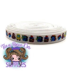 May include: A roll of white ribbon featuring a repeating pattern of colourful cartoon backpacks, school buses, and apples. The ribbon is tightly wound, ideal for crafting or gift wrapping. The logo "Tie a Bow On Supplies" is in the lower left corner.