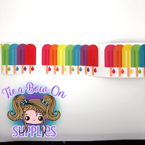 May include: White ribbon featuring a repeating pattern of colorful popsicle illustrations. Each popsicle is a different color of the rainbow, with a wooden stick and dripping water droplets. The ribbon is perfect for crafting and DIY projects.