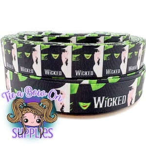 May include: A roll of black ribbon featuring a repeating pattern of the word "Wicked" and a stylized image of a green witch's face. The ribbon also has a white background and green accents.