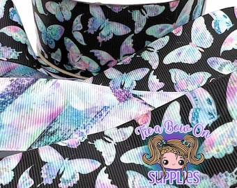 May include: Black and white ribbon with a watercolour butterfly print. The butterflies are in shades of purple, pink, blue, and green. The ribbon is 2.5 inches wide.