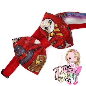 May include: Red and white bow tie with a Harry Potter themed print featuring a snowy owl, a wizard's hat, and a chest. The bow tie is attached to a red headband with a black clip.