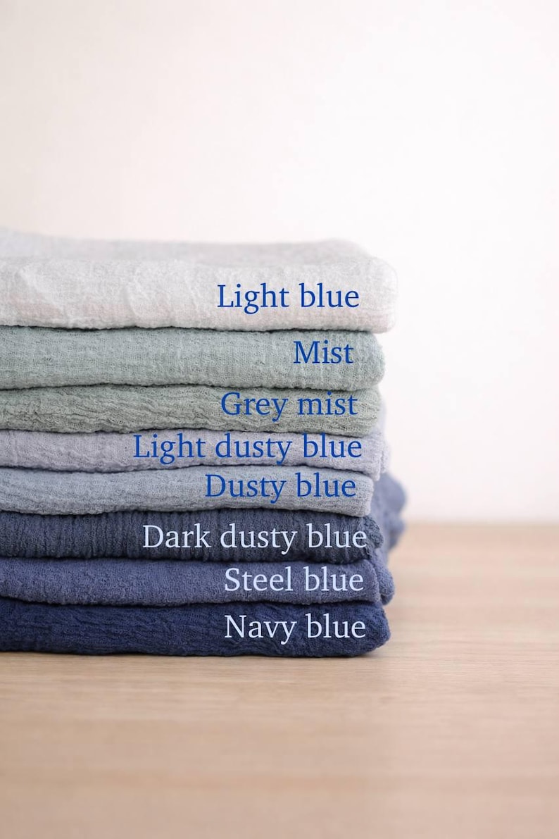 A stack of various colored towels, each labeled with a different color, arranged in a visually appealing manner.
