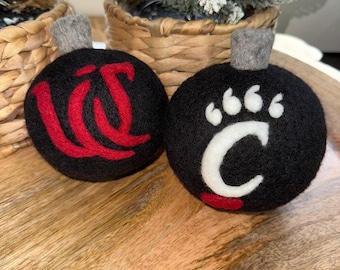 University of Cincinnati black monogram and paw print logo ornament.