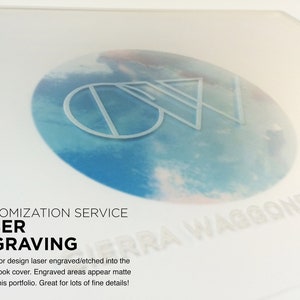 May include: A white background with the text "CUSTOMIZATION SERVICE LASER ENGRAVING" and the text "ERRA WAGGONER DESIGN" in a circle with a blue and white cloudy background. The text "Your logo or design laser engraved/etched into the portfolio book cover. Engraved areas appear matte white on this portfolio. Great for lots of fine details!" is also included.