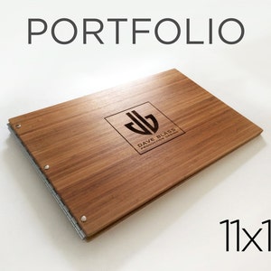 May include: A wooden portfolio with a silver hinge and a logo that says "Dave Blas Production Design". The portfolio is 11x17 inches.
