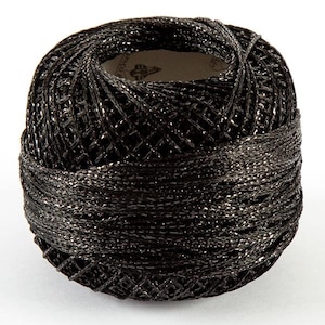 May include: A black ball of metallic thread with a silver sheen. The thread is wound around a white label with black text.
