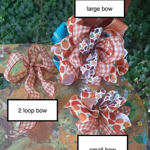 May include: Three decorative bows featuring various patterns including orange pumpkins, autumn leaves, and orange and white gingham. The collection includes a large bow, a small bow, and a 2 loop bow, each labelled with its respective name in white text boxes.
