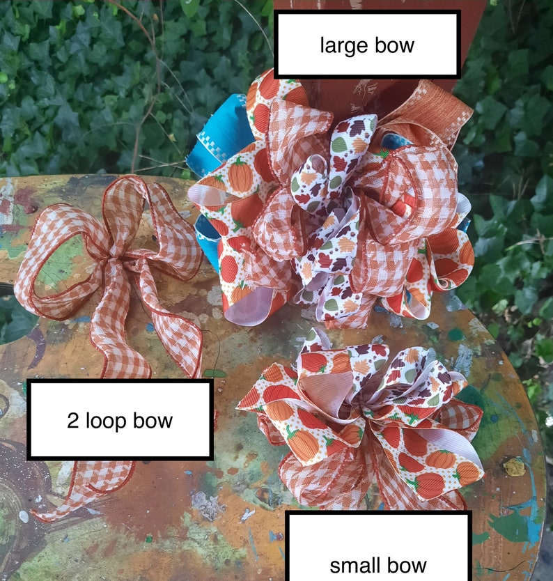 May include: Three decorative bows featuring various patterns including orange pumpkins, autumn leaves, and orange and white gingham. The collection includes a large bow, a small bow, and a 2 loop bow, each labelled with its respective name in white text boxes.