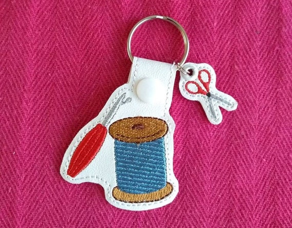 Sewing notions and scissors ITH embroidery design.  Seam ripper-thread-scissors