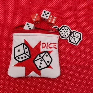 May include: White fabric dice bag with a red star and dice embroidered on it. The bag has a zipper closure and says "DICE" in red embroidery. There are four dice outside the bag, three red and one white.