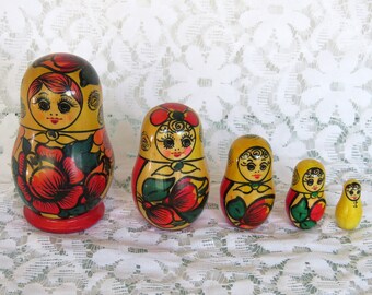 Vintage wooden set of 5 stacking babushka dolls matryoshka traditional Russian floral decoration red yellow